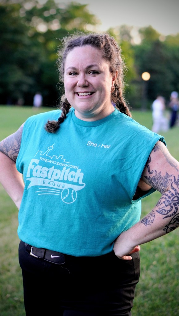 Photo of 2026 TDFL volunteer, Allyson. Allyson is wearing a teal-coloured T-shit with the TDFL logo and smiles at the camera.